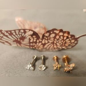 Set of four stud piercings